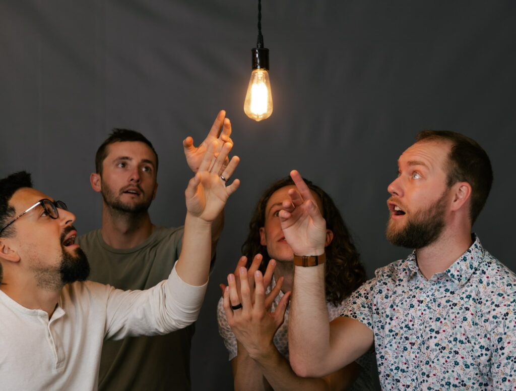 The Kalamazoo SEO team at Kzoom looking at a lightbulb.