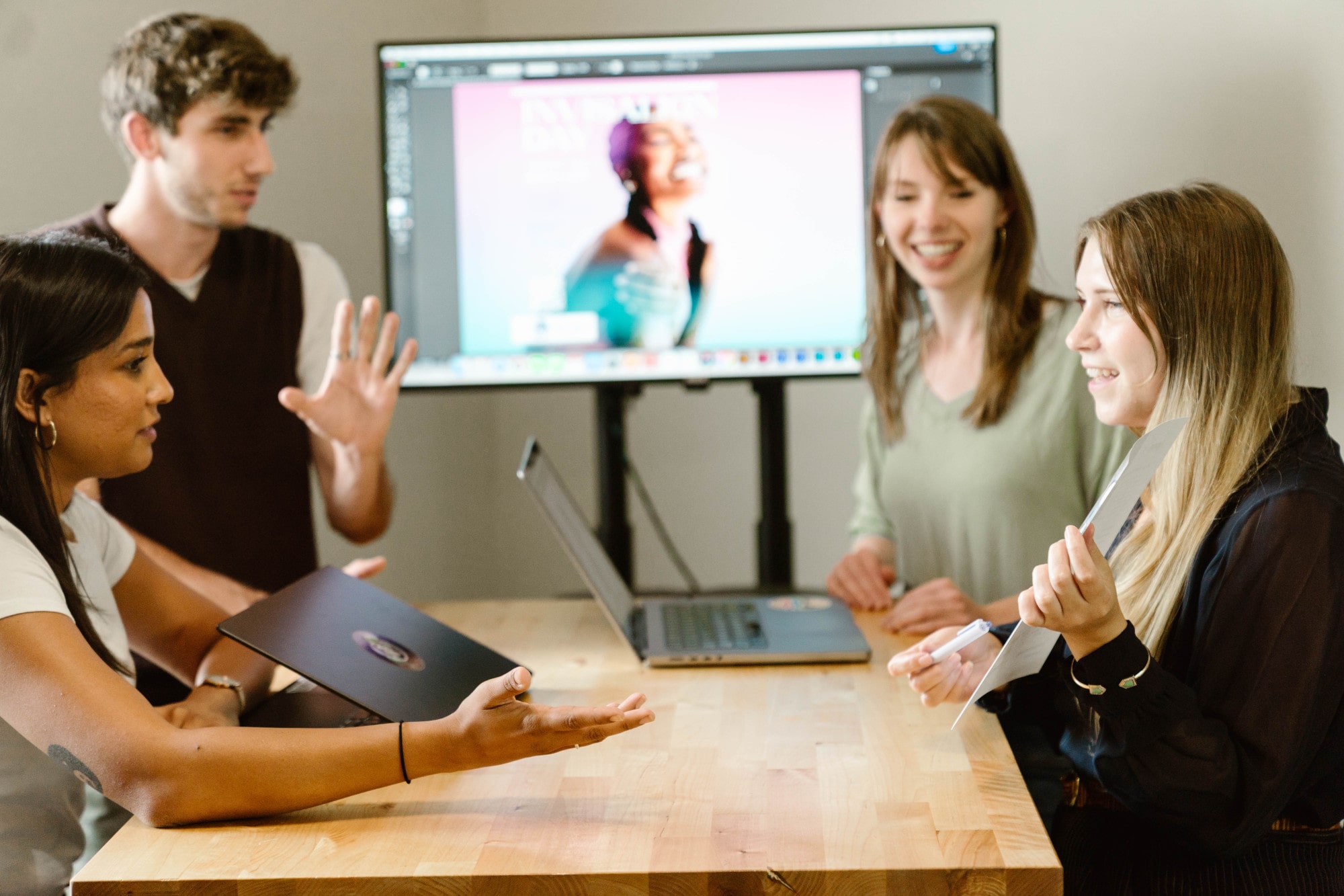 A group of marketers around a table discussing a marketing strategy.