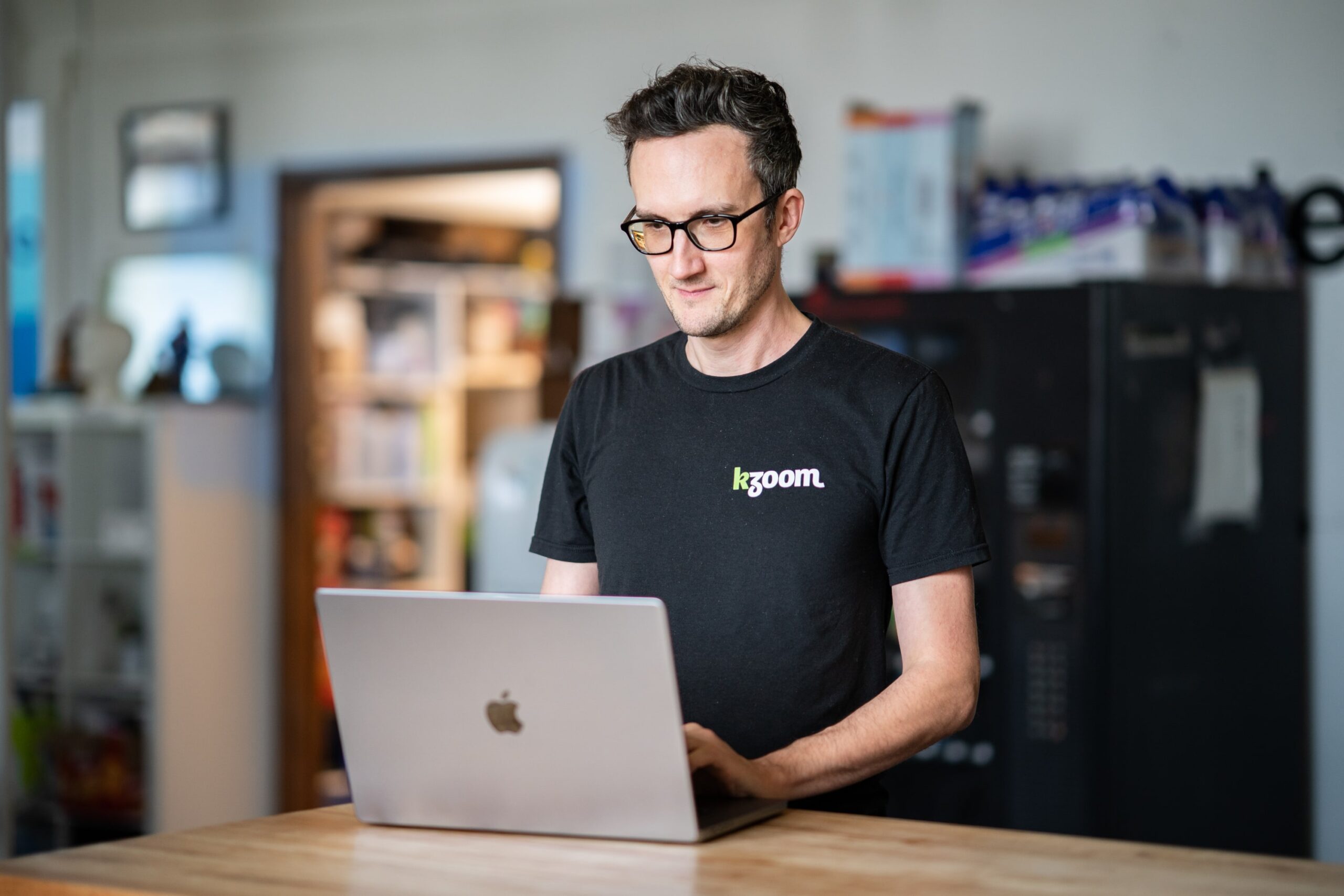 Kzoom's SEO specialist working on gathering Google reviews at an office table.